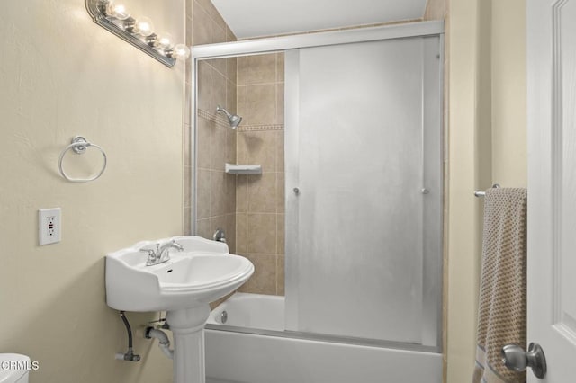 full bathroom with bath / shower combo with glass door