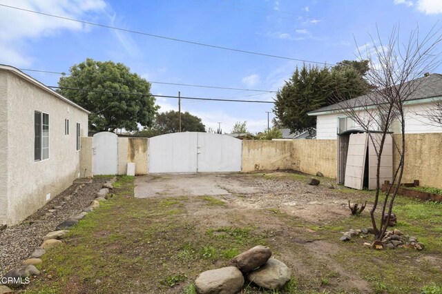 view of yard featuring fence and a gate
