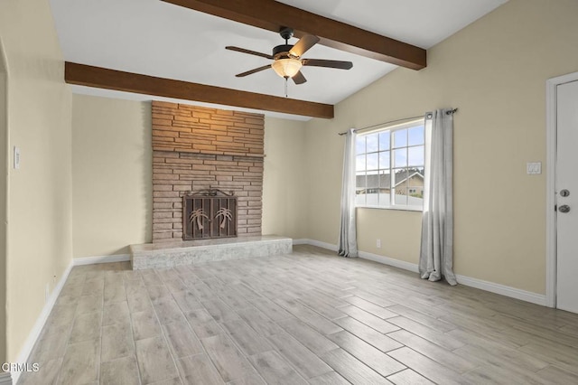 unfurnished living room with beamed ceiling, baseboards, ceiling fan, and a fireplace