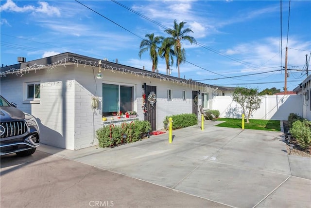 exterior space with brick siding and fence