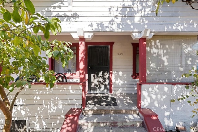 view of exterior entry with covered porch