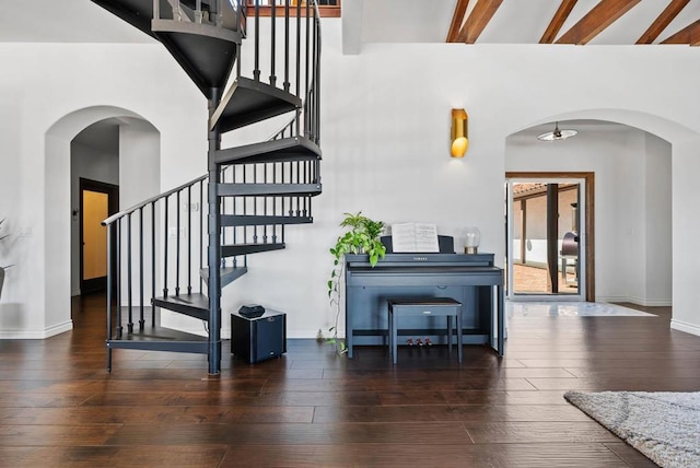 24949 Thunder Mountain Rd, Ramona, CA 92065 - stairway with arched walkways, beam ceiling, baseboards, and hardwood / wood-style floors