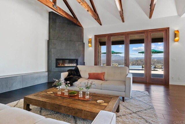 24949 Thunder Mountain Rd, Ramona, CA 92065 - living area featuring a tiled fireplace, wood finished floors, a mountain view, baseboards, and vaulted ceiling with beams