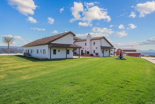 24949 Thunder Mountain Rd, Ramona, CA 92065 - back of house with a lawn, a tiled roof, a patio, and stucco siding