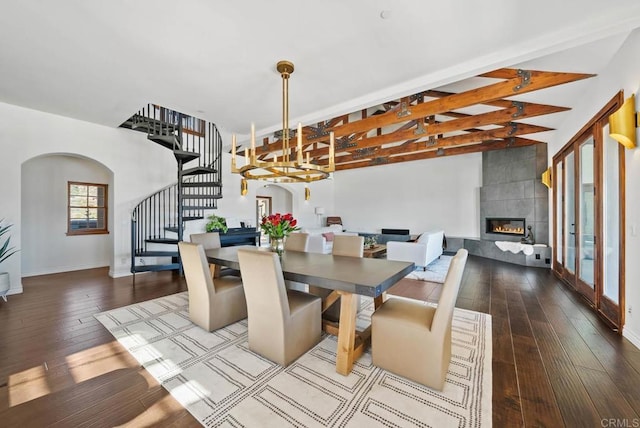 24949 Thunder Mountain Rd, Ramona, CA 92065 - dining area with arched walkways, hardwood / wood-style flooring, stairs, and a tiled fireplace
