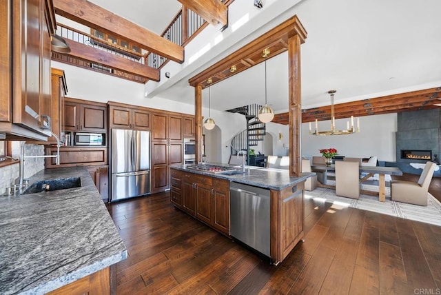 24949 Thunder Mountain Rd, Ramona, CA 92065 - kitchen with open floor plan, dark wood finished floors, appliances with stainless steel finishes, a fireplace, and a towering ceiling