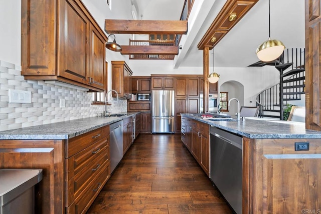 24949 Thunder Mountain Rd, Ramona, CA 92065 - kitchen featuring arched walkways, a sink, stainless steel appliances, dark wood-type flooring, and tasteful backsplash