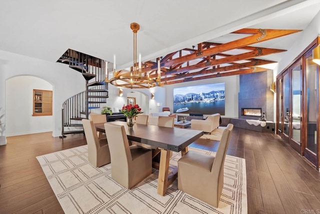 24949 Thunder Mountain Rd, Ramona, CA 92065 - dining room with beamed ceiling, stairway, arched walkways, wood-type flooring, and a tile fireplace