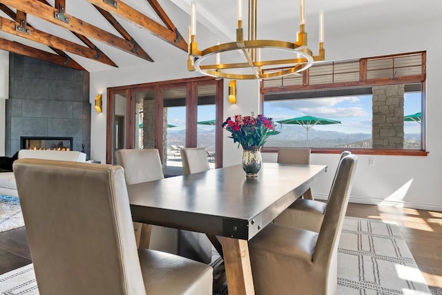 24949 Thunder Mountain Rd, Ramona, CA 92065 - dining room featuring vaulted ceiling with beams, baseboards, an inviting chandelier, wood finished floors, and a glass covered fireplace