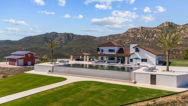 24949 Thunder Mountain Rd, Ramona, CA 92065 - back of house featuring a yard, an outbuilding, a mountain view, an infinity pool, and a patio