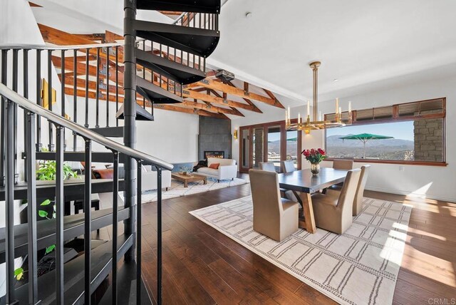 24949 Thunder Mountain Rd, Ramona, CA 92065 - dining space with stairway, beam ceiling, a fireplace, wood-type flooring, and a notable chandelier