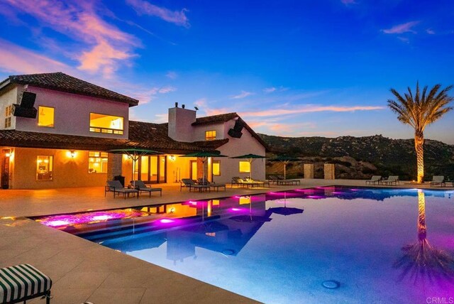 24949 Thunder Mountain Rd, Ramona, CA 92065 - pool at dusk featuring a patio and an outdoor pool
