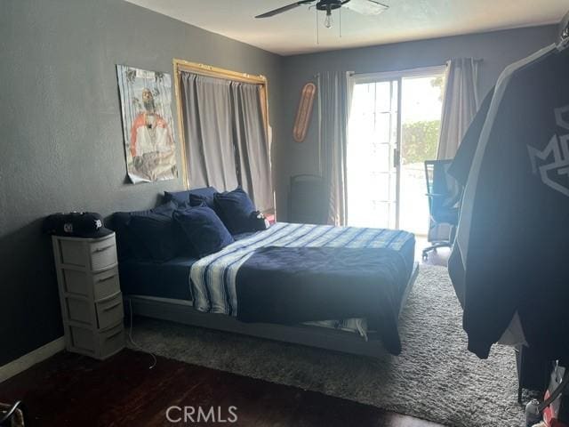 bedroom with dark wood-type flooring and ceiling fan
