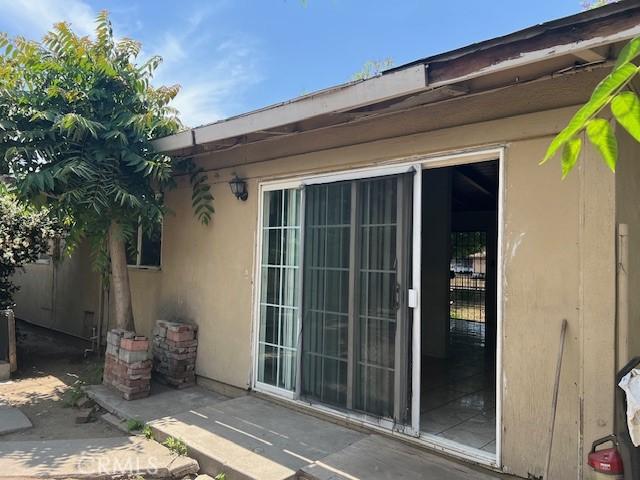 1320 N Grove Ave, Ontario, CA 91764 - property entrance featuring a patio area and stucco siding