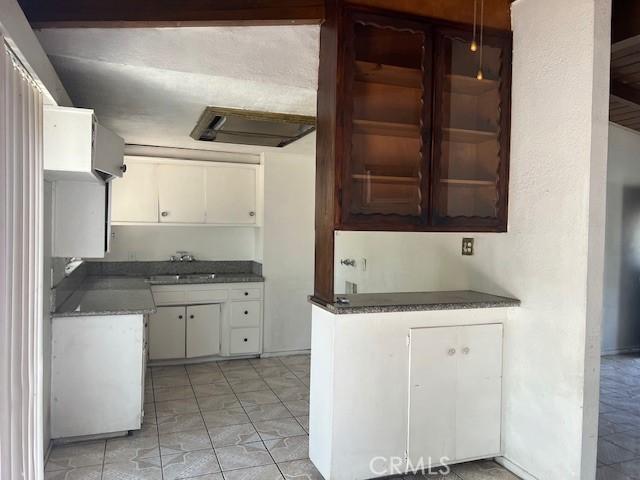 1320 N Grove Ave, Ontario, CA 91764 - kitchen featuring white cabinetry, a sink, and dark countertops