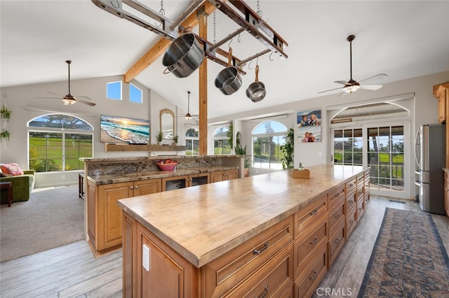 2913 Harris Dr, Vista, CA 92084 - kitchen with open floor plan, ceiling fan, a center island, and freestanding refrigerator