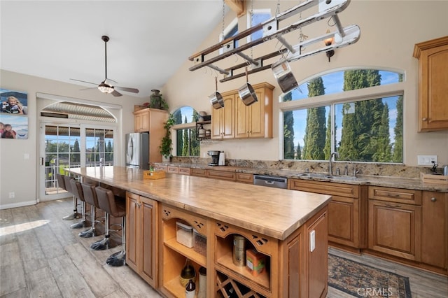 2913 Harris Dr, Vista, CA 92084 - kitchen featuring a center island, a sink, appliances with stainless steel finishes, and open shelves