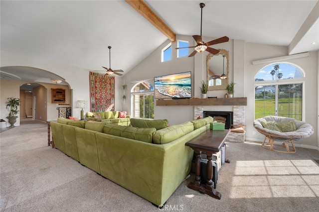 2913 Harris Dr, Vista, CA 92084 - carpeted living area featuring arched walkways, ceiling fan, beamed ceiling, and a fireplace with raised hearth