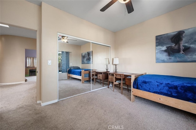 2913 Harris Dr, Vista, CA 92084 - carpeted bedroom featuring a ceiling fan, baseboards, a closet, and a fireplace