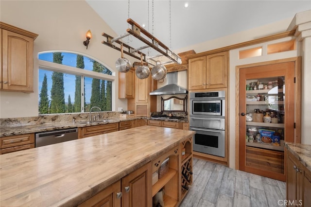 2913 Harris Dr, Vista, CA 92084 - kitchen featuring a sink, appliances with stainless steel finishes, wooden counters, lofted ceiling, and wall chimney range hood