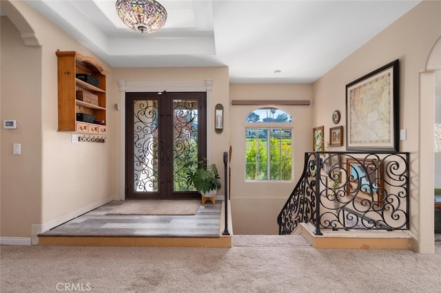 2913 Harris Dr, Vista, CA 92084 - foyer with carpet flooring, french doors, baseboards, a raised ceiling, and arched walkways