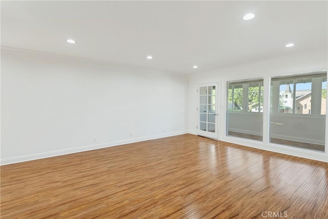 unfurnished room featuring ornamental molding, recessed lighting, baseboards, and light wood-type flooring