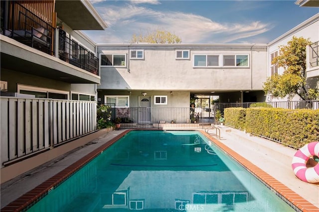 view of swimming pool featuring a fenced in pool and fence