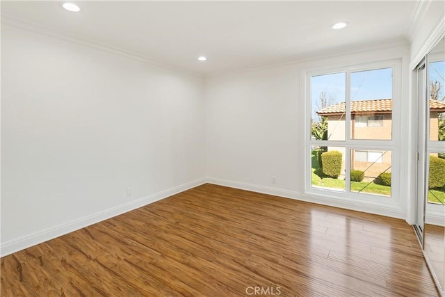 unfurnished room with baseboards, recessed lighting, ornamental molding, and wood finished floors