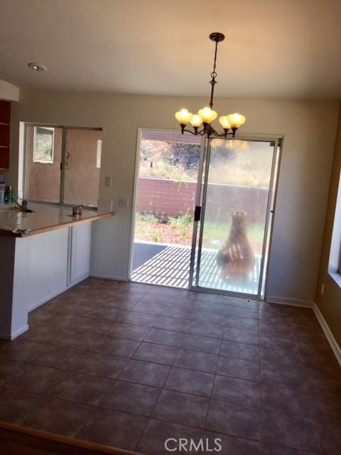 15205 Windjammer Way, Lake Elsinore, CA 92530 - unfurnished dining area with a chandelier and baseboards