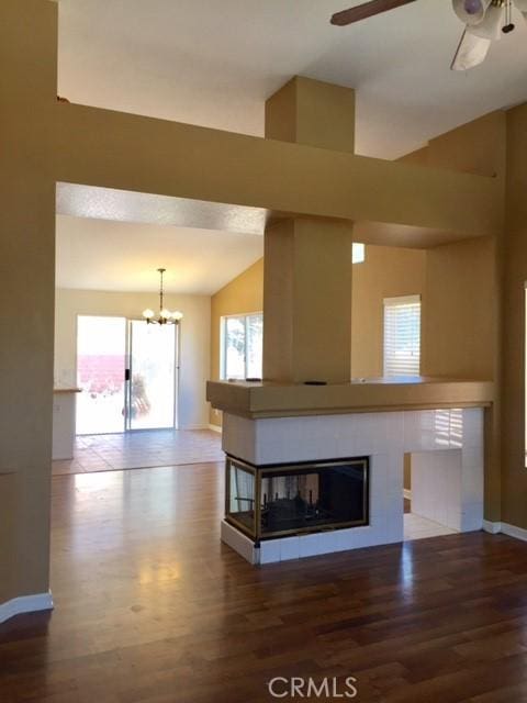 15205 Windjammer Way, Lake Elsinore, CA 92530 - unfurnished living room with ceiling fan, wood finished floors, a chandelier, plenty of natural light, and lofted ceiling