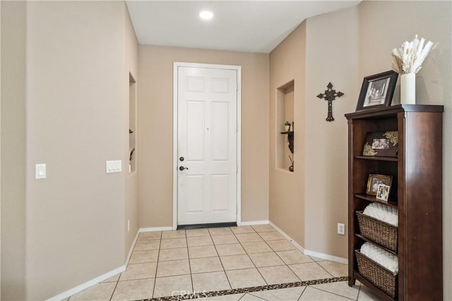 interior space with baseboards and light tile patterned floors