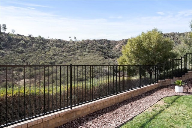 view of yard with fence and a mountain view