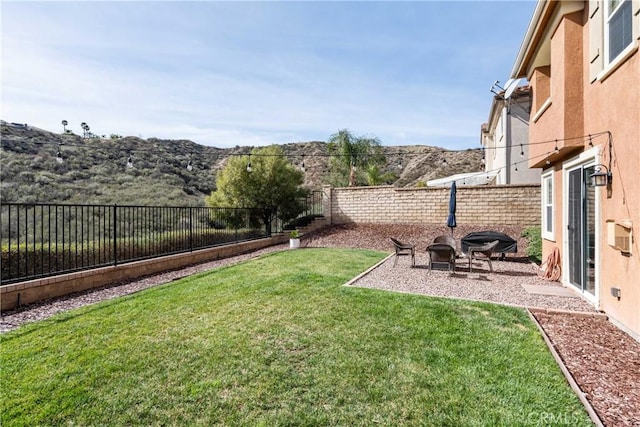 view of yard with a mountain view and a fenced backyard