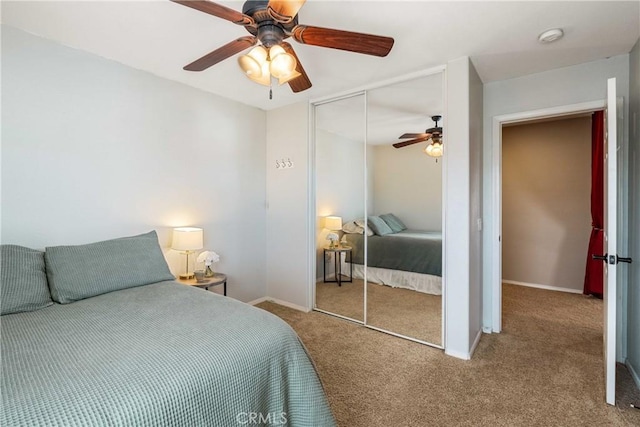 carpeted bedroom with baseboards, a ceiling fan, and a closet