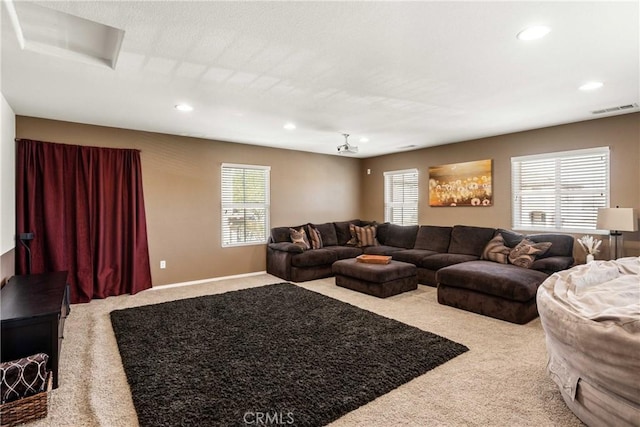 carpeted living room with visible vents, a wealth of natural light, and recessed lighting