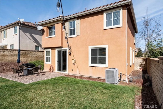 back of property featuring a patio area, central AC unit, a fenced backyard, a lawn, and stucco siding