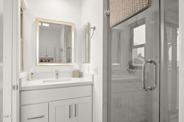 full bath with vanity and a shower stall