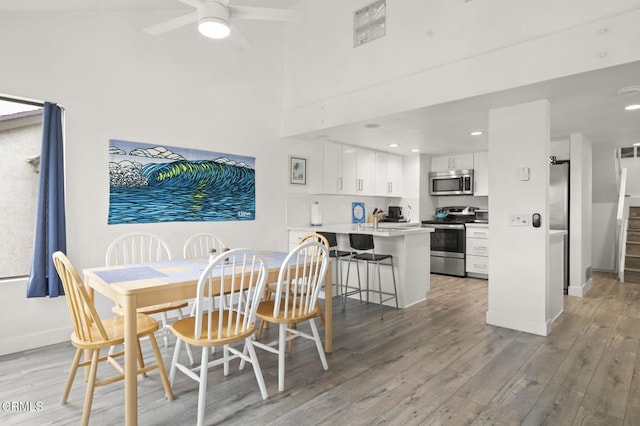 dining area with recessed lighting, light wood-style flooring, baseboards, and a ceiling fan