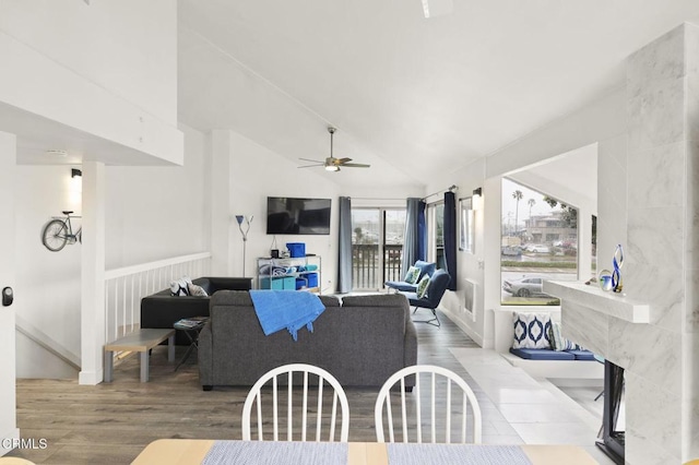 living room featuring high vaulted ceiling, wood finished floors, and a ceiling fan