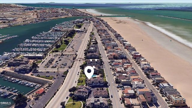 birds eye view of property with a view of the beach and a water view