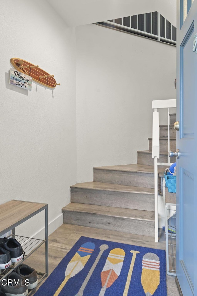 stairs with baseboards and wood finished floors