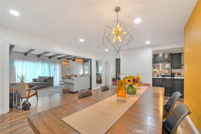 1027 W Durness St, West Covina, CA 91790 - dining area featuring a chandelier, wood finished floors, recessed lighting, beamed ceiling, and baseboards