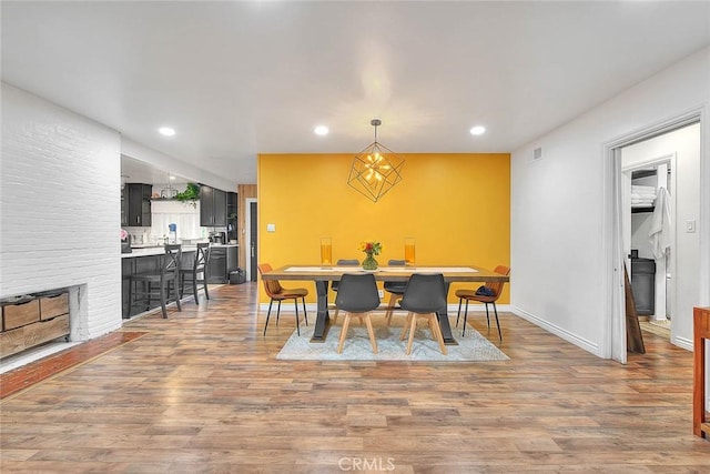 1027 W Durness St, West Covina, CA 91790 - dining area featuring wood finished floors, recessed lighting, baseboards, and a fireplace