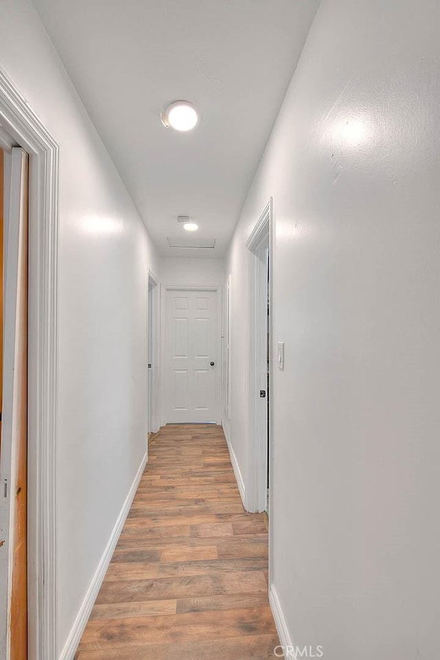 1027 W Durness St, West Covina, CA 91790 - corridor with light wood-type flooring and baseboards