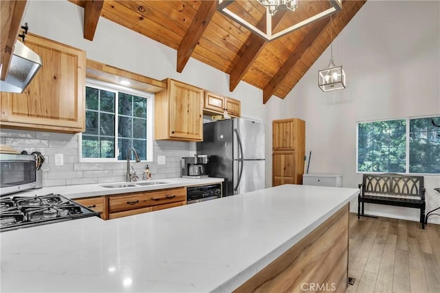 272 Fairway Dr, Lake Arrowhead, CA 92352 - kitchen featuring appliances with stainless steel finishes, a wood ceiling with exposed beams, decorative backsplash, light brown cabinetry, and light wood finished floors