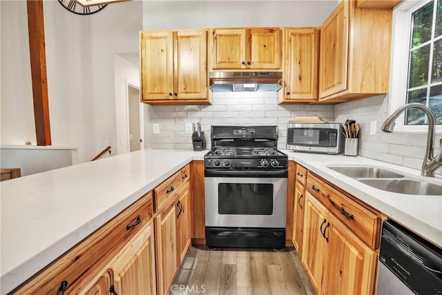 272 Fairway Dr, Lake Arrowhead, CA 92352 - kitchen featuring appliances with stainless steel finishes, under cabinet range hood, light countertops, light wood-style floors, and tasteful backsplash