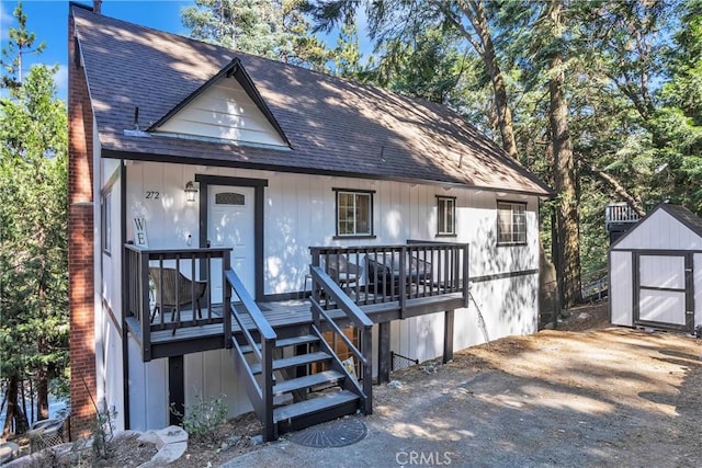 272 Fairway Dr, Lake Arrowhead, CA 92352 - view of front facade with a storage unit, stairs, a shingled roof, and a deck