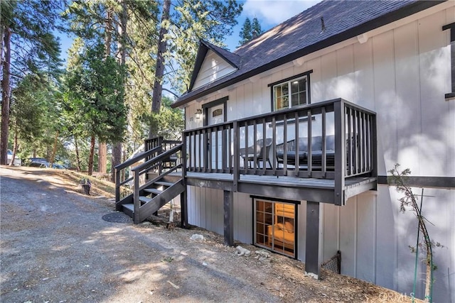 272 Fairway Dr, Lake Arrowhead, CA 92352 - view of home's exterior with a shingled roof, stairway, and a wooden deck