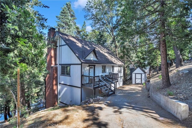 272 Fairway Dr, Lake Arrowhead, CA 92352 - view of front facade with a chimney, a shed, and a porch