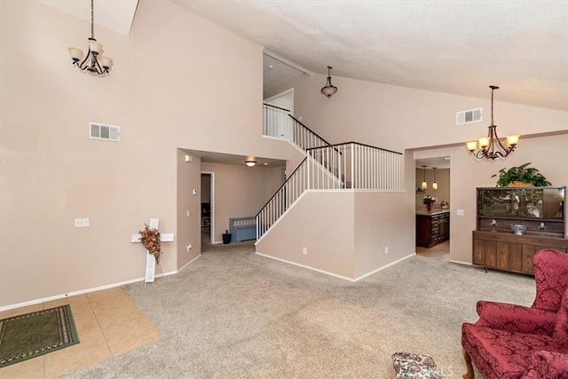 718 Cherry St, Corona, CA 92881 - tiled living room with an inviting chandelier, visible vents, and carpet floors